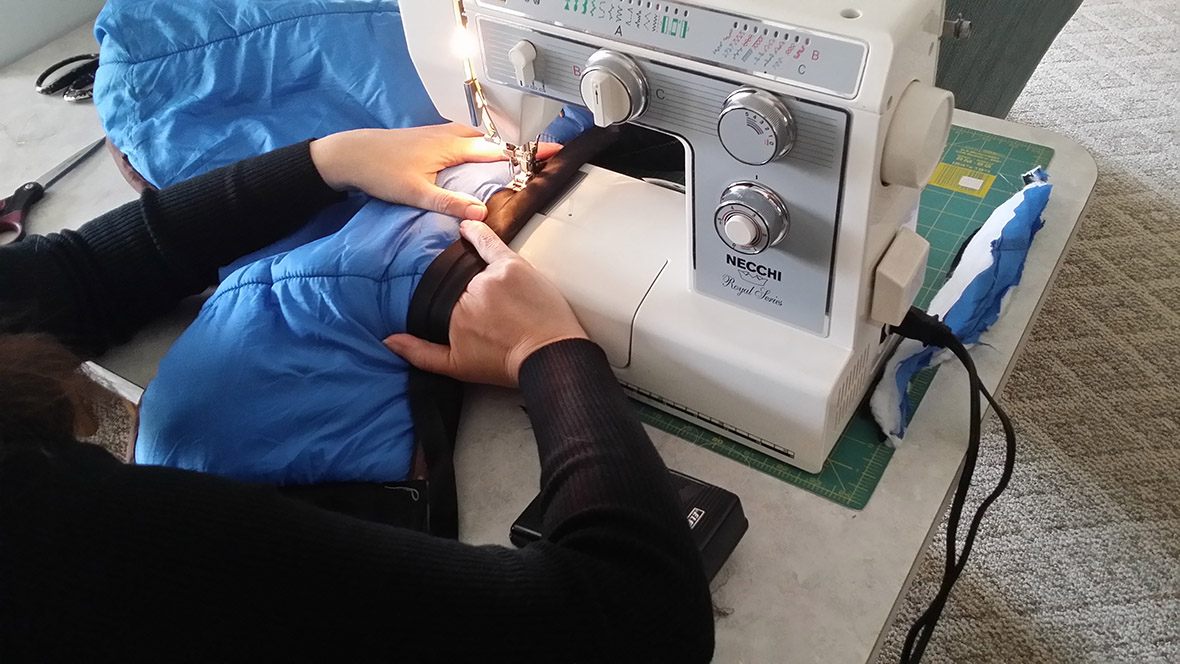 Kimberley sewing at her machine, hands crafting in Whitefish, MT